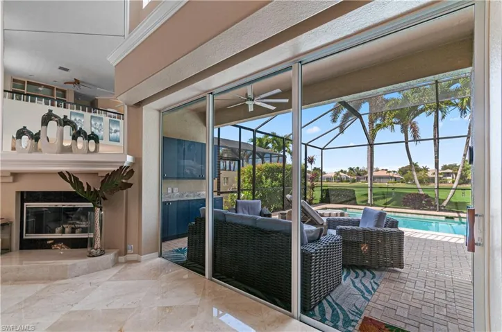 View of patio featuring an outdoor pool, a ceiling fan, a sunroom, a lanai, and outdoor lounge area
