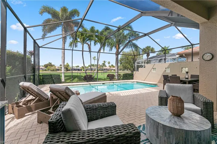 Swimming pool featuring a sunroom, a patio, and a lanai
