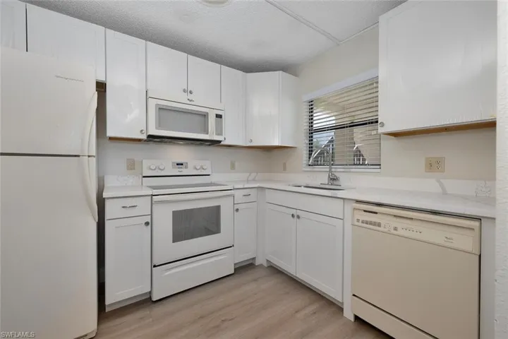 Kitchen featuring white appliances