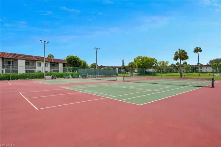 View of tennis court with community basketball court