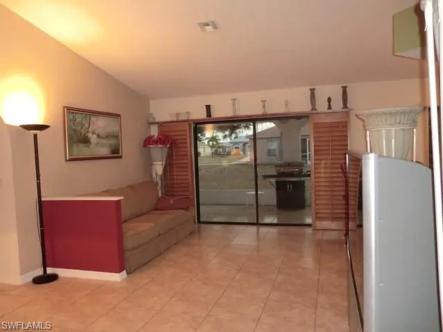 Open concept living area with vaulted ceilings and tile flooring