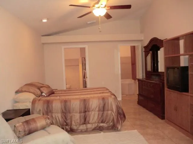 Vaulted ceiling featuring a ceiling fan with integrated lighting