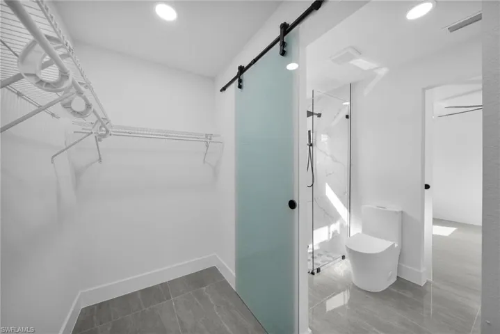 Walk in closet featuring a barn door