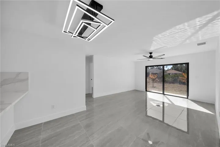 Unfurnished room with baseboards and a ceiling fan