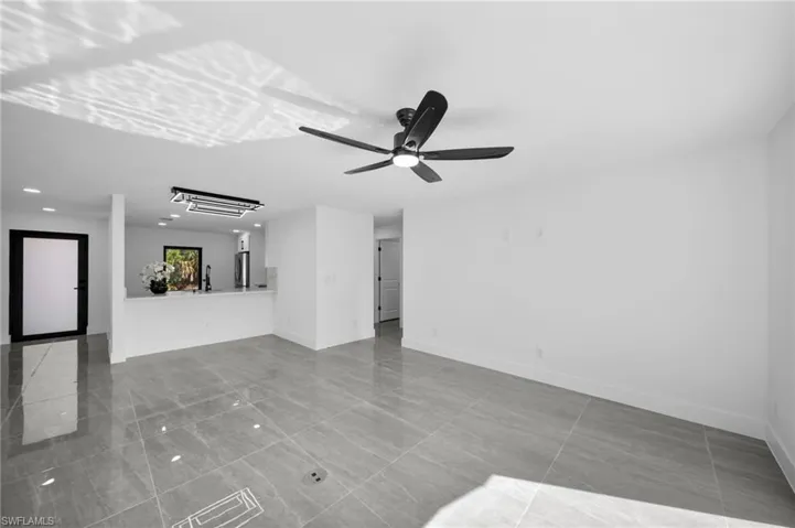 Unfurnished living room featuring a ceiling fan and recessed lighting