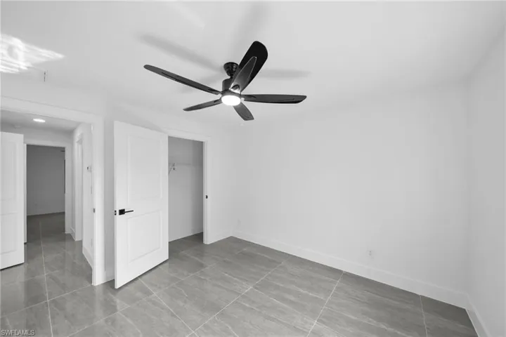 Unfurnished bedroom with a closet and a ceiling fan