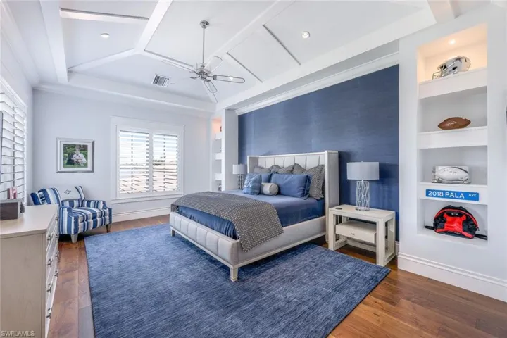 Bedroom with dark wood finished floors and a ceiling fan
