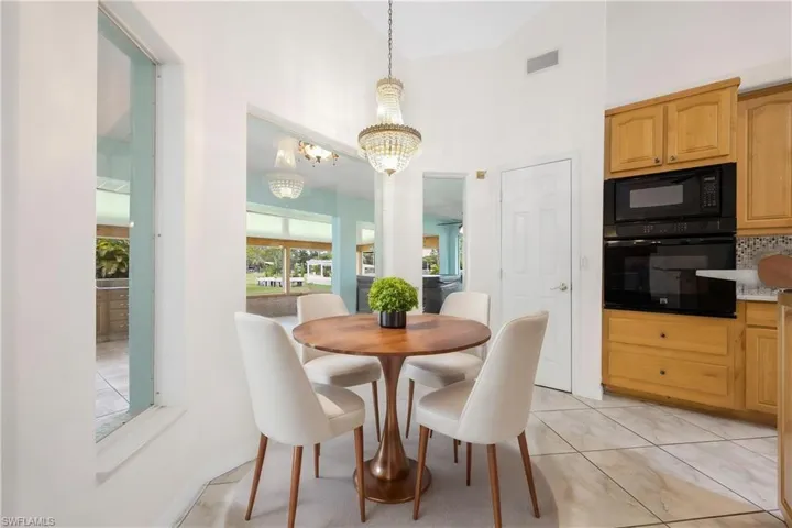 Dining space with a chandelier and vaulted ceiling