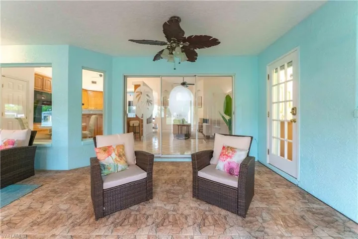 Living area featuring ceiling fan and a textured ceiling