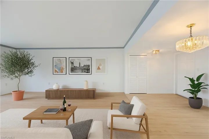 Virtually Staged with new flooring and furniture reference.  Dining room under a chandelier would complete a grand living space.