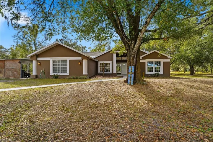 View of front of property with stucco siding and a front yard