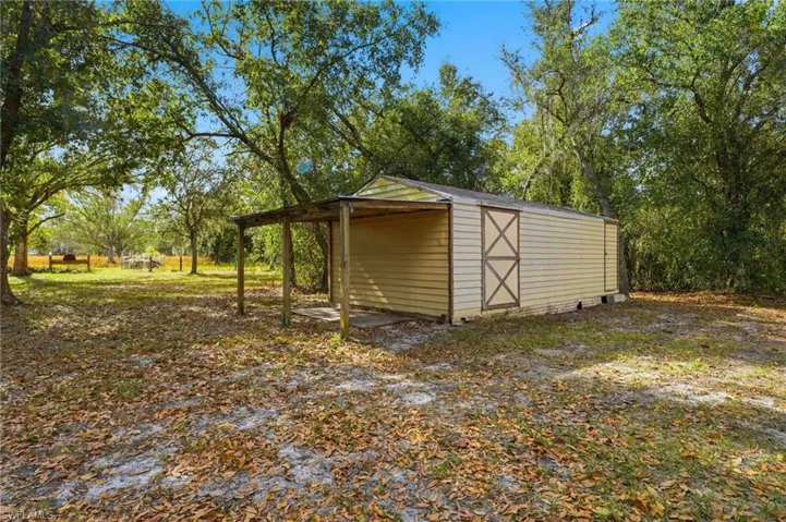 View of outbuilding featuring a carport