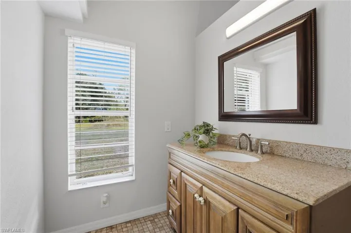 Bathroom featuring vanity and baseboards