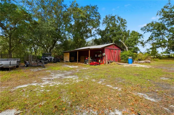 View of yard with an outdoor structure and a pole building