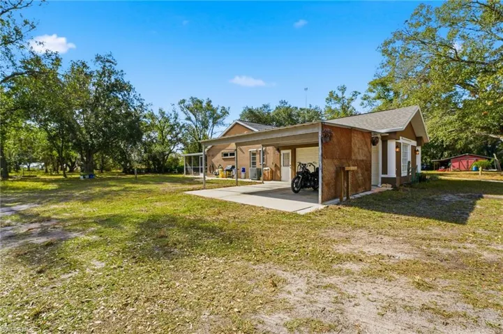 Rear view of house featuring a lawn