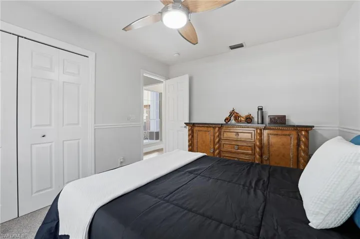 Bedroom featuring a closet, a ceiling fan, and carpet