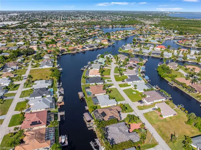 Aerial view of property's location with a large body of water and nearby suburban area