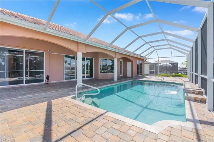 Outdoor pool with a sunroom, a lanai, and a patio