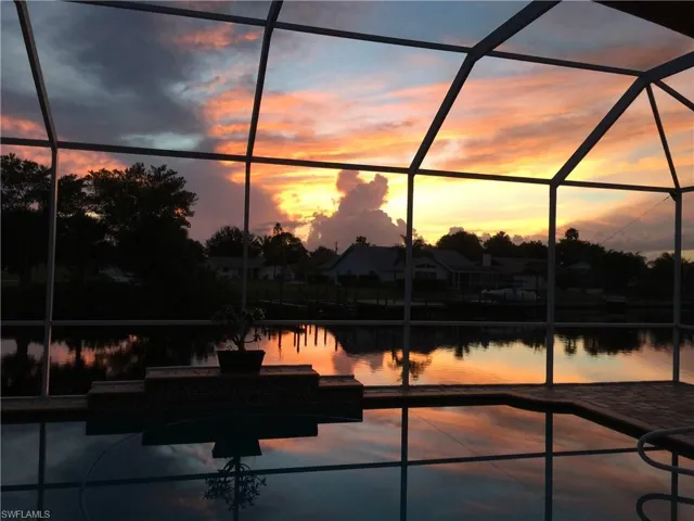 View of patio with a sunroom, a lanai, and a water view