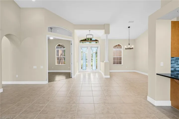 Foyer entrance featuring light tile patterned flooring and a chandelier