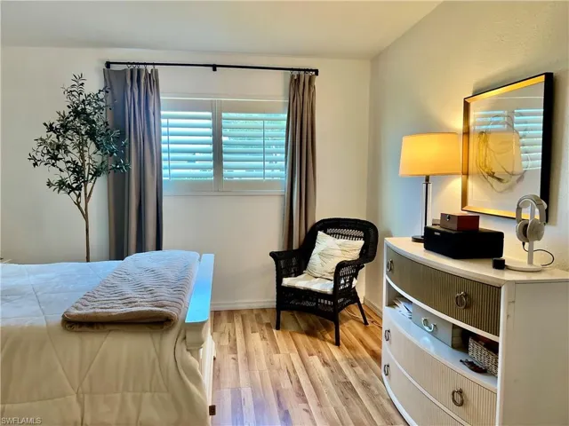 Bedroom featuring light wood finished floors and baseboards