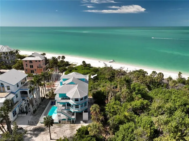 Aerial view featuring a water view and a view of the beach