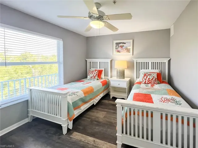 Bedroom featuring ceiling fan, dark wood finished floors, and baseboards