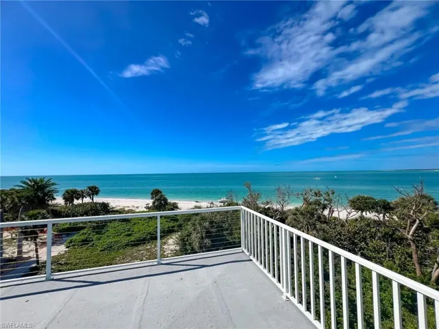 Balcony with a water view and a beach view