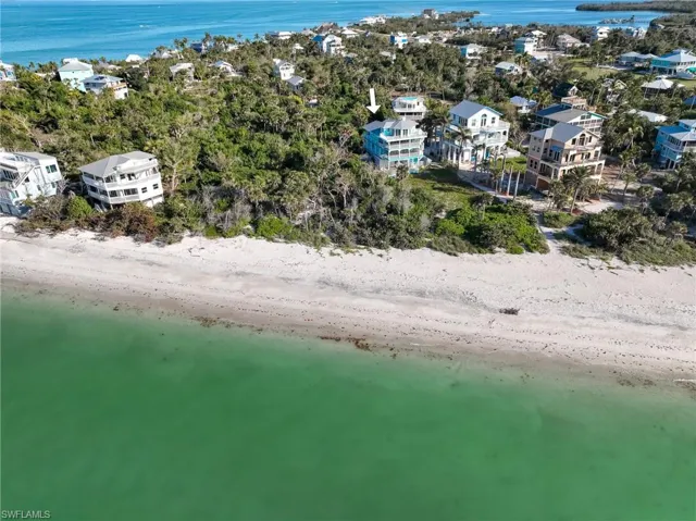 Aerial view with a water view and a beach view