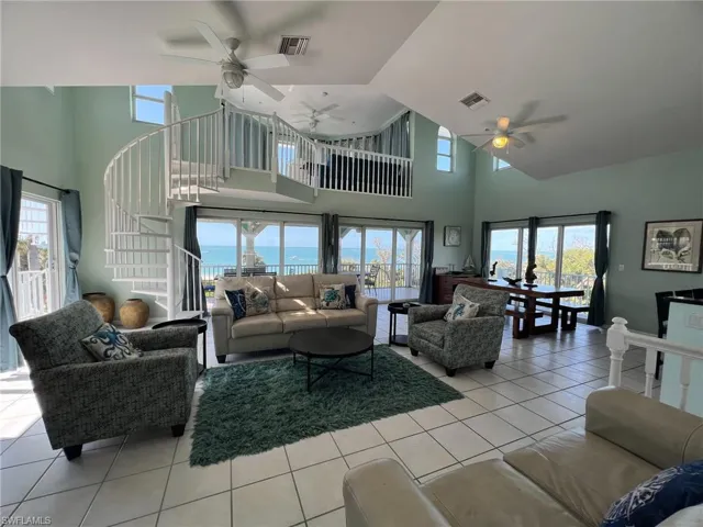 Living area featuring a wealth of natural light, a water view, and visible vents