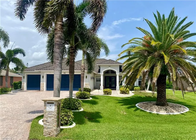 Mediterranean / spanish house with a garage and a front yard