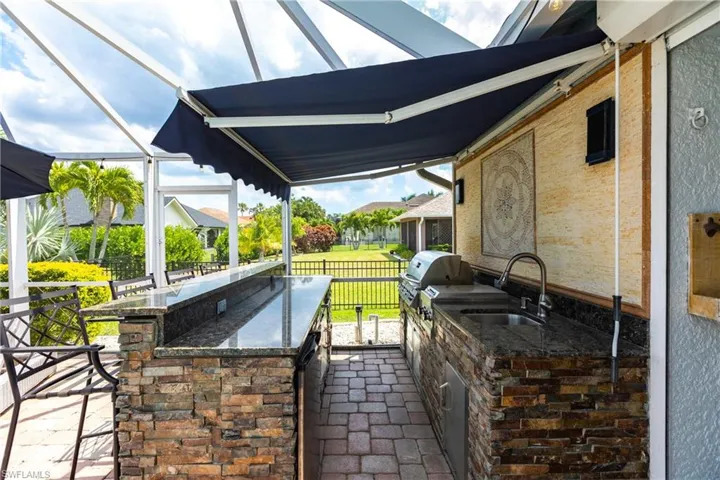 View of patio / terrace with sink, an outdoor kitchen, and area for grilling