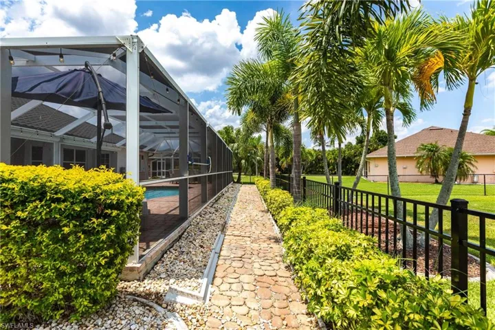 View of yard with glass enclosure and a fenced in pool