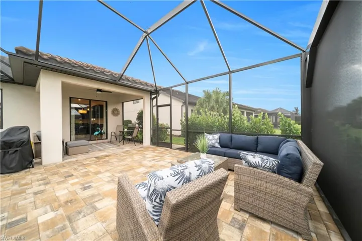 View of patio / terrace with a sunroom, a lanai, ceiling fan, area for grilling, and outdoor lounge area