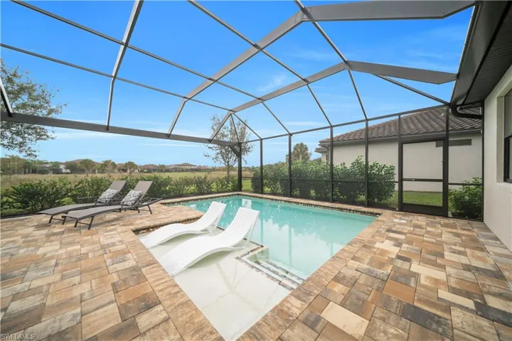 Outdoor pool with a lanai, a sunroom, and a patio
