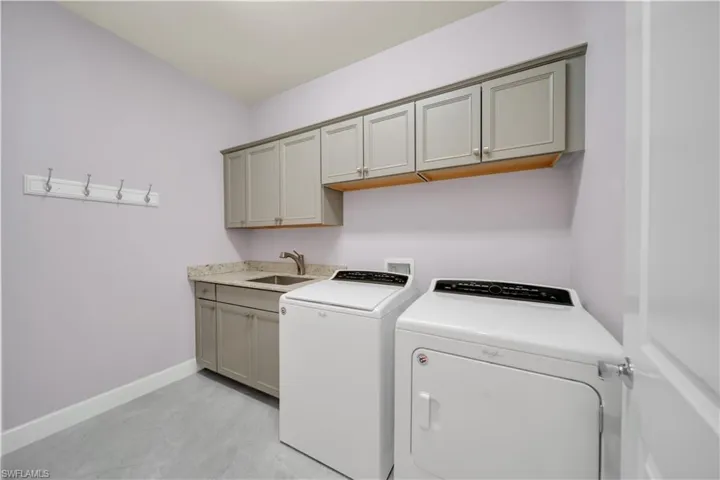 Washroom with cabinet space and washer and dryer