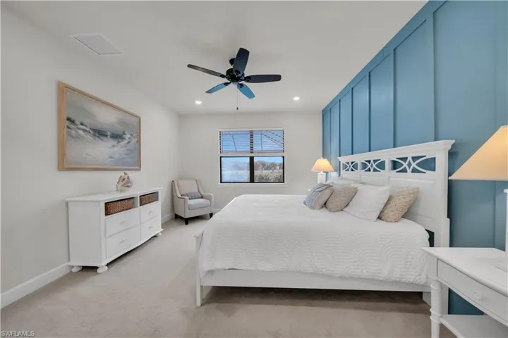 Bedroom featuring light carpet, ceiling fan, and recessed lighting