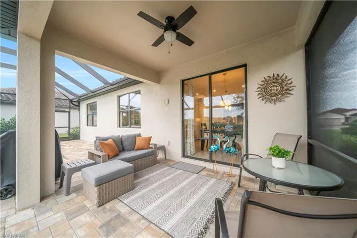 View of patio / terrace featuring a sunroom, glass enclosure, and a ceiling fan