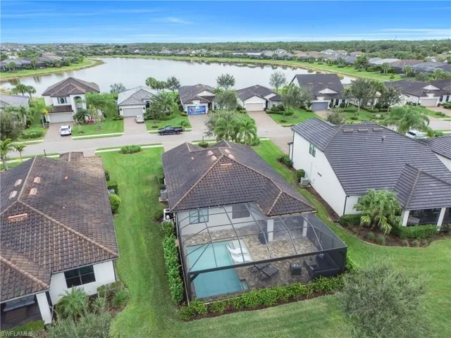 Aerial view of residential area featuring a large body of water