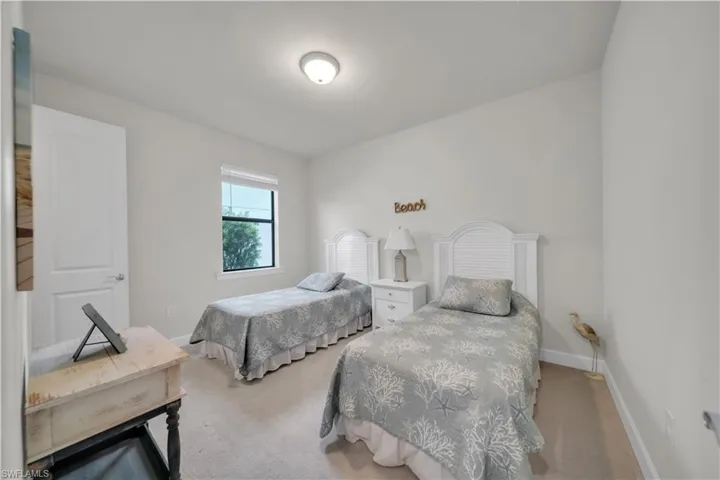 Bedroom with carpet flooring and baseboards