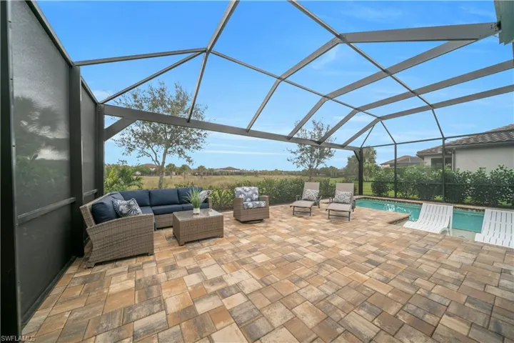 View of patio / terrace with a lanai, a sunroom, and an outdoor pool