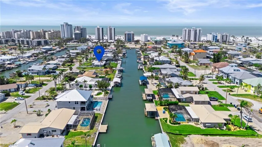 Birds eye view of property with a water view and a view of city  - Virtually Edited Image