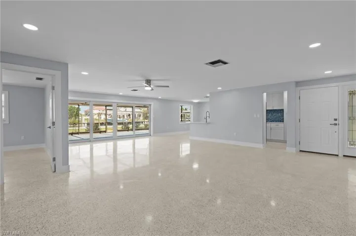 Great room featuring terrazzo floor, baseboards. virtually edited photo.