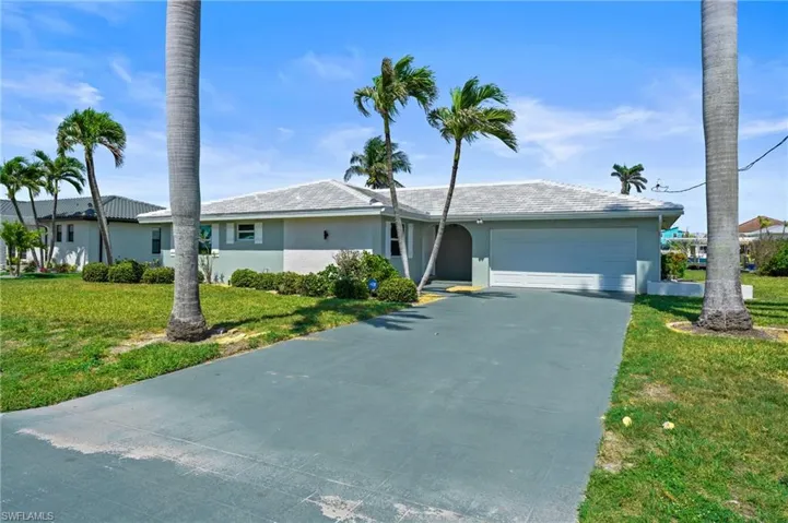 Single story home with driveway, stucco siding, an attached garage, and a front lawn. Virtually edited image.