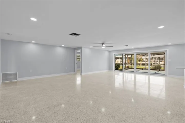 Great room with visible vents, terrazzo floor, recessed lighting, and a ceiling fan. Virtually edited photo.
