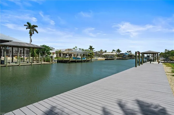 View of dock featuring a water view on canal.  Virtually edited photo.