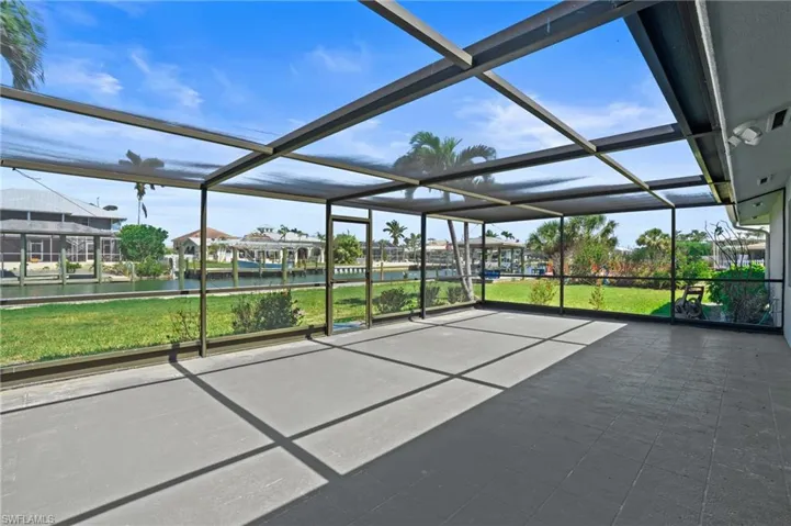 Screened in lanai featuring a water view. Virtually edited photo.