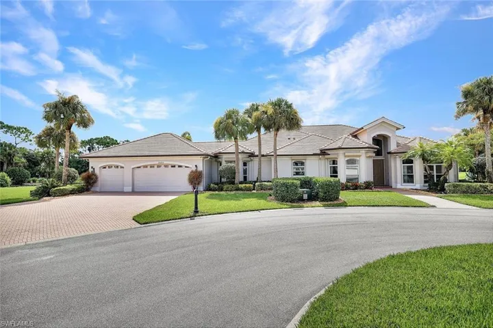 Ranch-style house with a front lawn and a garage