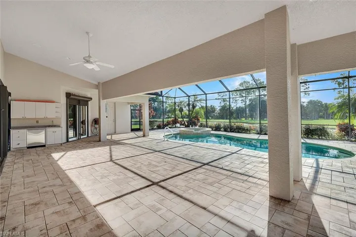 View of pool featuring a lanai, an in ground hot tub, a patio, and ceiling fan