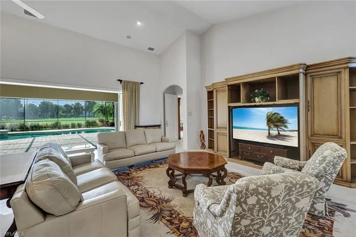 Living room with high vaulted ceiling